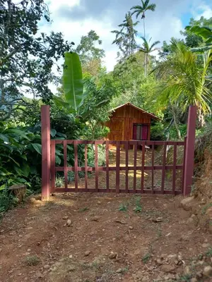 a wooden fence in front of a small house at La cabaña de Eugenio in Convento