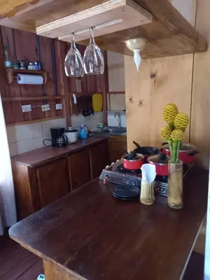 a kitchen with a wooden counter top with pots and pans at La cabaña de Eugenio in Convento