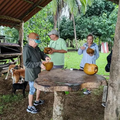 a group of people standing around a table with food at Mangrove boat tour lalo it is just a tour in Quepos