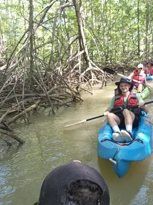 a person in a kayak in the water with a paddle at Mangrove boat tour lalo it is just a tour in Quepos