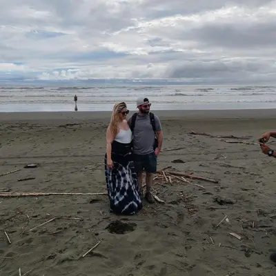 a man and a woman standing on the beach at Mangrove boat tour lalo it is just a tour in Quepos