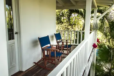 two chairs sitting on the porch of a house at Hotel Horizontes de Montezuma in Montezuma
