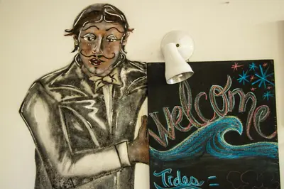 a drawing of a man standing next to a sign at Hotel Horizontes de Montezuma in Montezuma