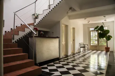 a hallway with a staircase and a checkered floor at Hotel Horizontes de Montezuma in Montezuma