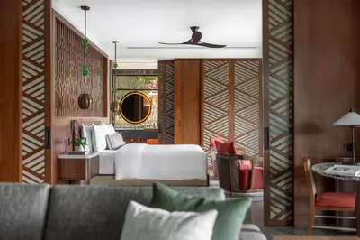 a hotel room with a bed and a couch at Nekajui Peninsula Papagayo, a Ritz-Carlton Reserve in Papagayo, Guanacaste