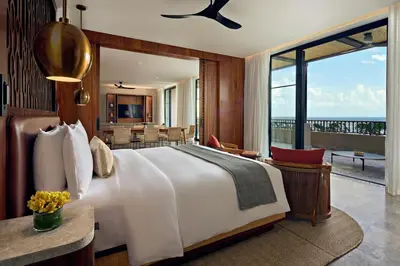 a bedroom with a large bed and a balcony at Nekajui Peninsula Papagayo, a Ritz-Carlton Reserve in Papagayo, Guanacaste