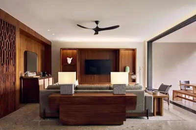 a living room with a couch and a tv at Nekajui Peninsula Papagayo, a Ritz-Carlton Reserve in Papagayo, Guanacaste
