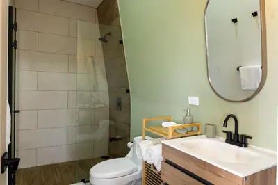 a bathroom with a toilet and a sink and a shower at Stylish Oasis Retreat with Modern Amenities & Scenic Views in San Rafael