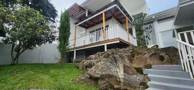 a house with a balcony on top of a pile of rocks at Stylish Oasis Retreat with Modern Amenities & Scenic Views in San Rafael