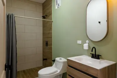 a bathroom with a toilet and a sink and a mirror at Stylish Oasis Retreat with Modern Amenities & Scenic Views in San Rafael