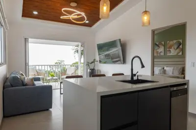 a kitchen with a sink and a living room at Stylish Oasis Retreat with Modern Amenities & Scenic Views in San Rafael
