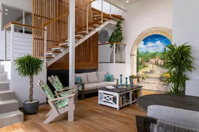 a living room with a spiral staircase in a house at Stylish Oasis Retreat with Modern Amenities & Scenic Views in San Rafael
