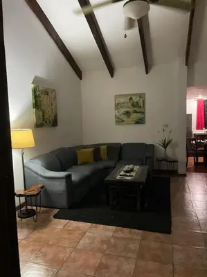 a living room with a couch and a table at Sea view Apartment in Puerto Limón