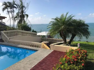 a swimming pool with a view of the ocean at Ocean view Apartment in Puerto Limón