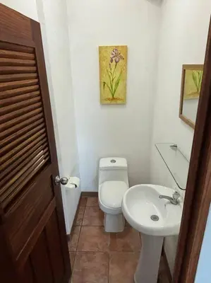 a bathroom with a white toilet and a sink at Coral view Apartment in Puerto Limón