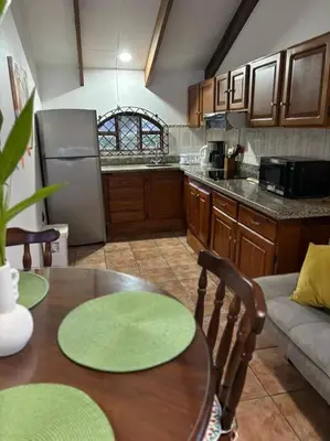 a kitchen with a table and a refrigerator at Coral view Apartment in Puerto Limón