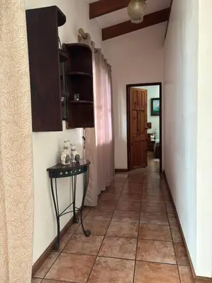 a hallway of a house with a table and a room at Coral view Apartment in Puerto Limón