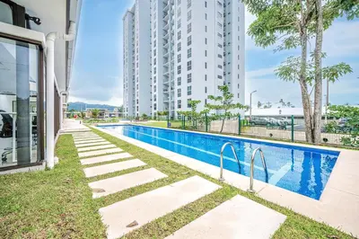 a swimming pool in front of a tall building at Viva Jaco 1305 in Jacó