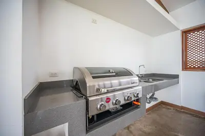 a kitchen with a stove and a sink at Viva Jaco 1305 in Jacó