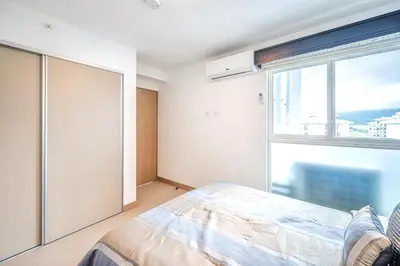 a bedroom with a bed and a large window at Viva Jaco 1305 in Jacó