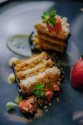 a plate with two pieces of cake and a strawberry at Vista Suites at Parador - Adults Only in Manuel Antonio