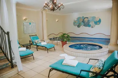 a waiting room with a hot tub and chairs at Vista Suites at Parador - Adults Only in Manuel Antonio