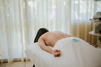 a naked woman laying on a bed in a room at Vista Suites at Parador - Adults Only in Manuel Antonio