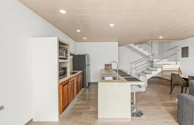 a kitchen with a counter and a staircase in a house at Casa amor del sol apartment # 2 in Quebrada Ganado