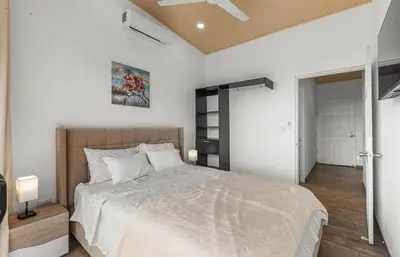 a bedroom with a bed and a ceiling fan at Casa amor del sol apartment # 2 in Quebrada Ganado