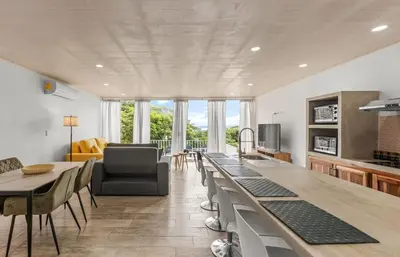 a living room with a long table and a couch at Casa amor del sol apartment # 2 in Quebrada Ganado
