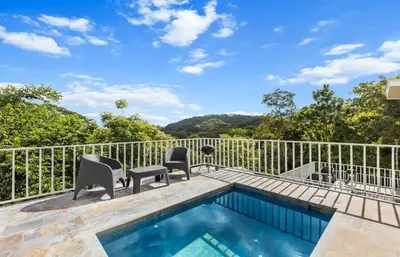 a patio with a swimming pool and chairs next to a fence at Casa amor del sol apartment # 2 in Quebrada Ganado