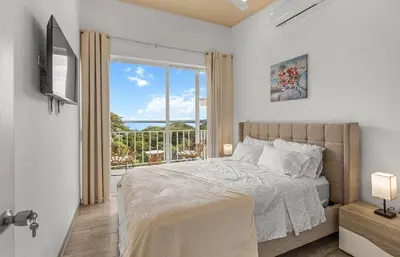 a bedroom with a bed and a large window at Casa amor del sol apartment # 2 in Quebrada Ganado