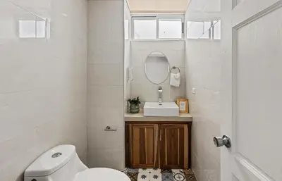 a bathroom with a toilet and a sink and a mirror at Casa amor del sol apartment # 2 in Quebrada Ganado