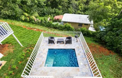 an overhead view of a swimming pool with two chairs at casa amor del sol apartment #1 in Quebrada Ganado