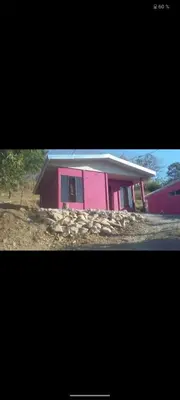 a pink house with a white roof at Puertohumo in Puerto Humo
