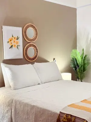 a bedroom with a bed with two plates on the wall at Hotel VillaFlores in Quesada