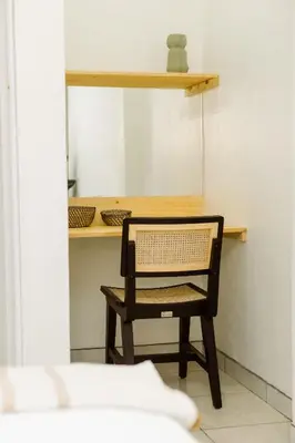 a chair sitting at a table in a room at Hotel VillaFlores in Quesada