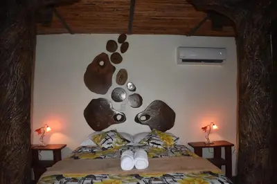 a bedroom with a face made out of rocks on the wall at Villa Girasol in Sarapiquí