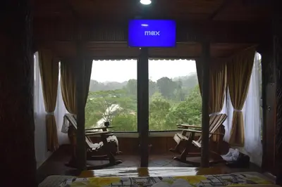 a sign in a room with chairs and a window at Villa Girasol in Sarapiquí