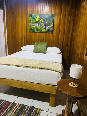 a bedroom with a bed and a table with a lamp at Casa 1856- cómodas habitaciones en el Centro de Alajuela in Alajuela City