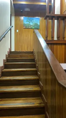a staircase in a building with a painting on the wall at Casa 1856- cómodas habitaciones en el Centro de Alajuela in Alajuela City