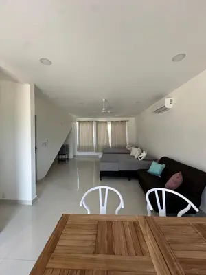 a living room with a couch and a table and two chairs at Hotel Bella Tamarindo Guanacaste in Tamarindo