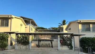 a gazebo in the middle of a yard with houses at Hotel Bella Tamarindo Guanacaste in Tamarindo