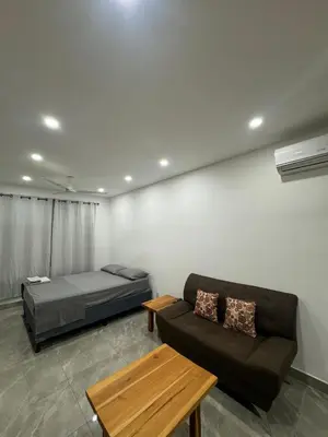 a living room with a couch and a bed at Hotel Bella Tamarindo Guanacaste in Tamarindo