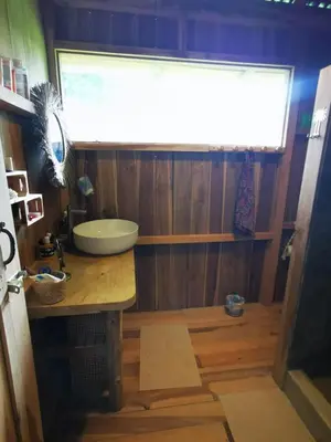 a bathroom with a sink and a large window at Papaya Lodge in Bijagua