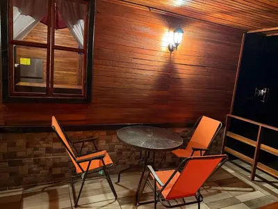 a table and chairs in front of a wooden wall at Colonial Guanacaste Villas in Guanacaste