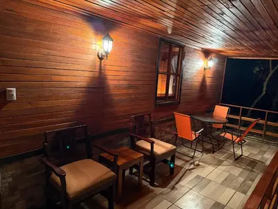 a room with chairs and a table and a tv at Colonial Guanacaste Villas in Guanacaste