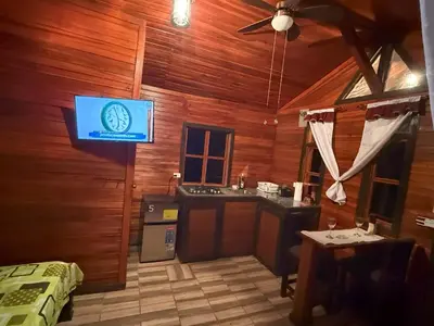a room with a television in a wooden wall at Colonial Guanacaste Villas in Guanacaste