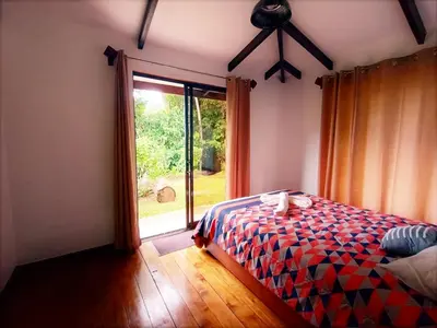 a bedroom with a bed and a large window at Aloha chirripo cabaña familiar in Convento