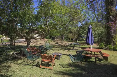 a picnic table with a purple umbrella and chairs at Airport Costa Rica B&B in Alajuela City